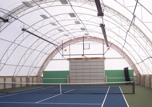 The inside of a fabric structure over a tennis court
