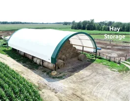 A fabric structure is seen being used on a farm. Greenfield Contractors builds fabric structures for grain storage in Bettendorf IA/