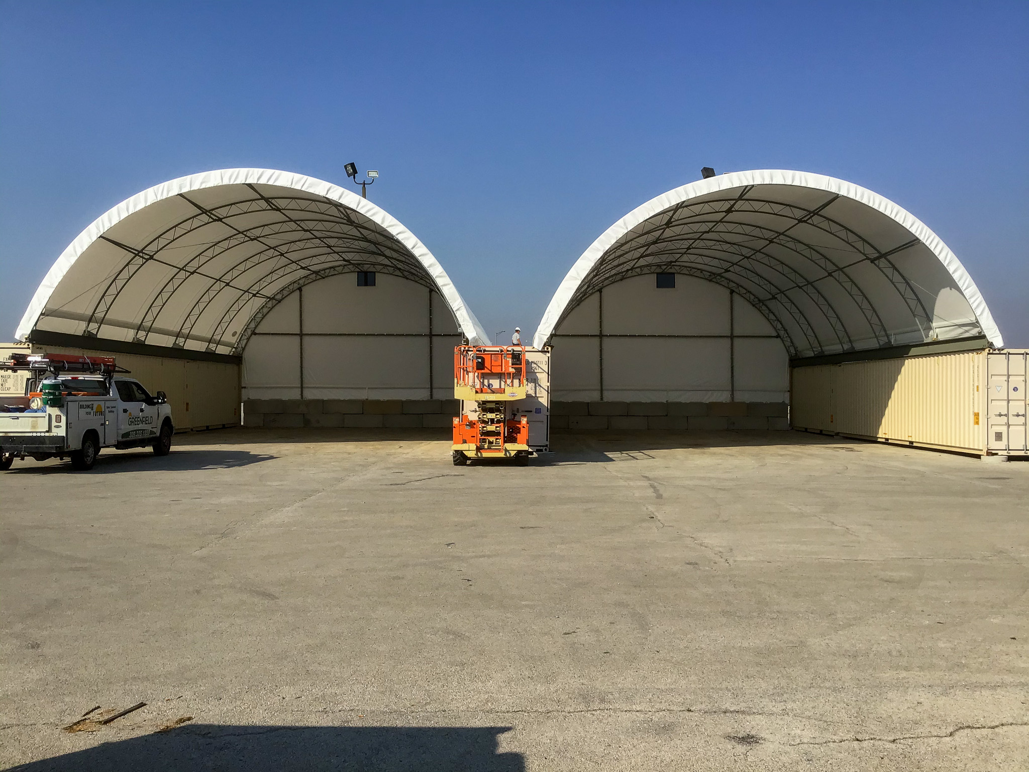 Two portable fabric structures are seen. Greenfield Contractors builds Portable Buildings in Bettendorf IA.